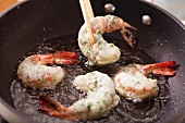 Frying prawns with herb and egg white coating