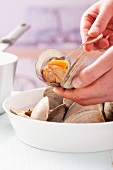 Removing cooked clam meat from shells