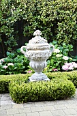 Trophy-shaped, antique Greek-style vessel in garden