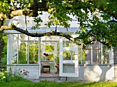 View of a traditional glass garden pavilion with an open door