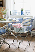 Breakfast table with English garden chairs, gingham cushions and romantic vintage-style accessories