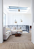 Bright seating area on upper storey of house with solid wooden floorboards