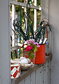 Trellis, flowers and ornaments on windowsill of garden shed