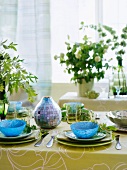 Colored place settings on a table with a tablecloth