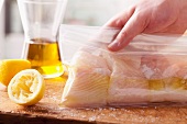 Halibut being marinated in a freezer bag