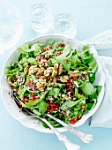 Mixed salad with pomegranate seeds and walnuts