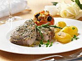 Sword fish steaks with roast potatoes and stuffed tomatoes