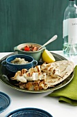 Chicken kebabs with flat bread, eggplant puree and tomato salsa