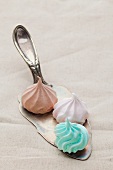 Pastel colored meringues on an antique silver cake slice