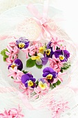 Heart-shaped flower wreath of violas and hyacinth florets