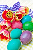 Easter eggs and bouquet of tulips