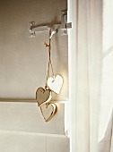 String with heart-shaped, wooden tags hanging on door handle