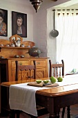 Apples and cutting board on a dining table in a traditional dining room