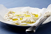 Cheese and Olive Oil Spread Appetizer with Black Pepper and a Knife