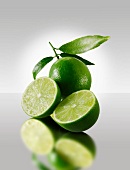 Two lime halves in front of a whole lime