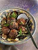 Chilli and pepper meatballs on fried aubergine