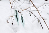 Silberner Baumschmuck im Schnee