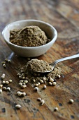 Ground cardamom in small bowl & on spoon