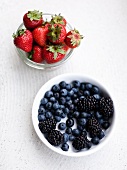 Strawberries, blueberries and blackberries in bowls