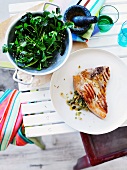 Grilled pork cutlet stuffed with olive pesto with watercress salad