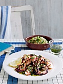 Octopus with Greek herb sauce and pea and mint pilaf