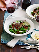 Grilled quail on a bed of salad