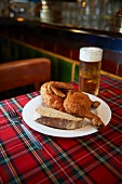 Half a chicken with bread and beer in a restaurant