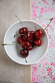 Red Cherries in a Small White Dish