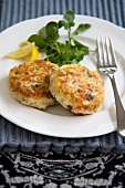 Two Salmon and Dill Fish Cakes on a Plate; Fork