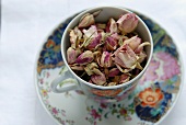 Dried rose flowers in an English teacup