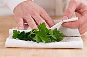 Patting parsley dry with paper towel