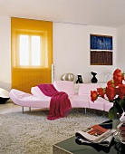 Pink sofa in modern living room in front of window with orange, transparent, sliding panel curtain