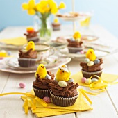 Chocolate cupcakes on a table decorated for Easter