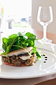 Sea bass on a bed of vegetables with water cress