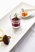 An appetizer platter with olive paste, beetroot soup and smoked salmon