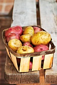 Various potatoes in a wooden basket