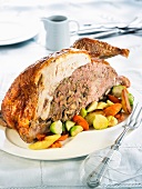Half a stuffed turkey with oven-roasted vegetables