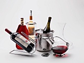 Wine accessories: a bottle stand, a cooling sleeve, a wine cooler, a champagne bucket, a decanter and a pouring aid