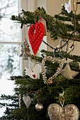 Christmas tree decorated with various heart-shaped ornaments and fairy lights
