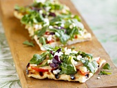 Grilled Focaccia Bread Topped with Arugula, Tomatoes and Crumbled Queso Cheese