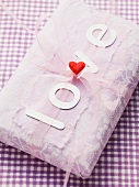 A grift-wrapped parcel with the word 'love'