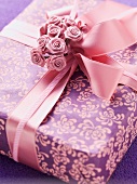 A gift box decorated with a bow and roses