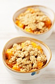 Two bowls of mango crumble