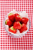 Fresh strawberries on a napkin in a glass bowl