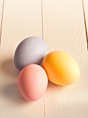 Three pastel coloured eggs