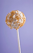 A cake pop with golden sprinkles