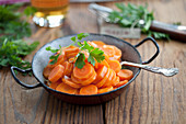 Fried carrots with shallots garnished with parsley