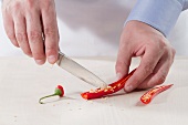 A chilli pepper being deseeded