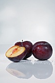 Plums, whole and halved