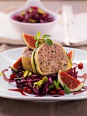 Minced venison meat loaf wrapped in courgettes on a bed of red cabbage